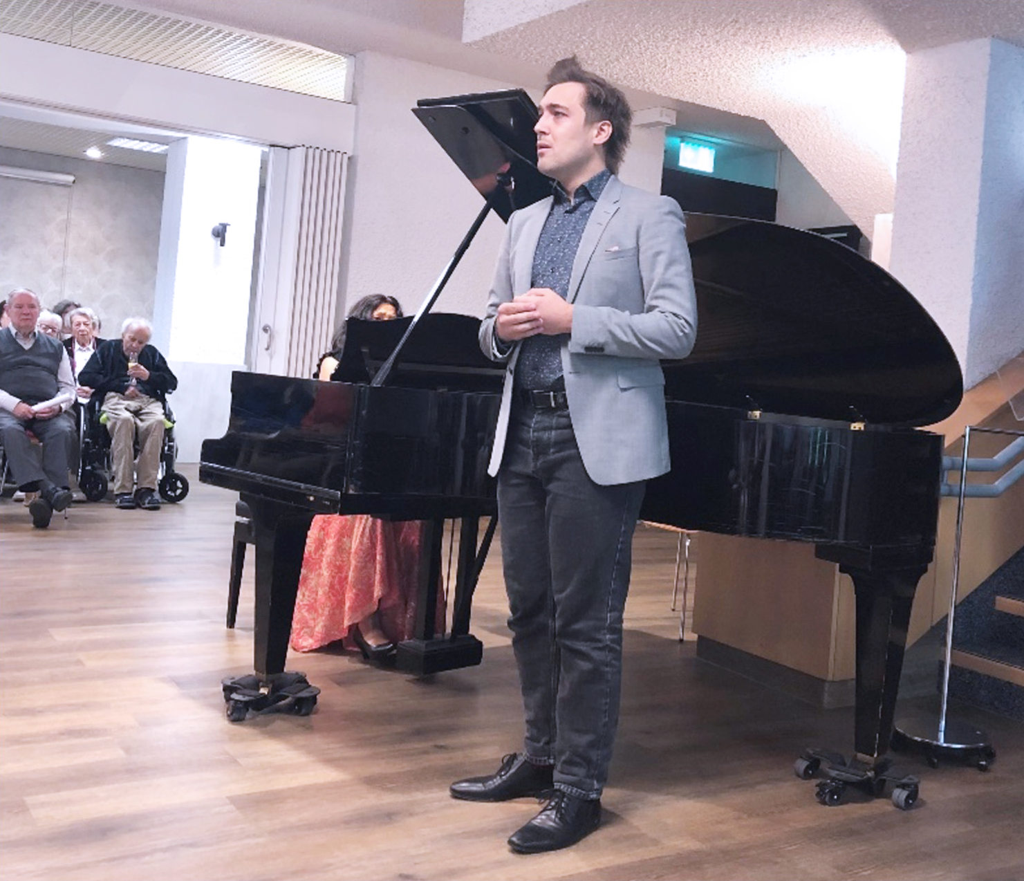 Sänger Jan-Henrik Witkowski singt beim Herbstempfang im Wohnstift Mönchfeld, begleitet von Pianistin Doriana Tchakarova am Flügel vor Publikum.